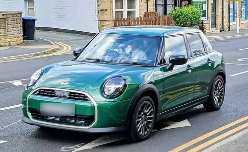 2025 MINI Cooper features a sleek, modernized design with a focus on technology and a premium feel. Key updates include a new circular OLED 